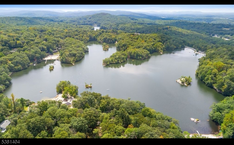 56 Sleepy Hollow Road Andover, NJ 07821 - Photo 2 of 37 an aerial view of lake and residential houses with outdoor space