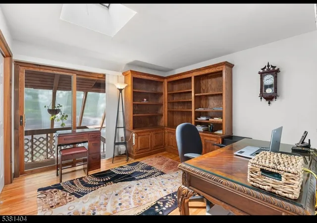 a bed sitting in a spacious bedroom next to a window
