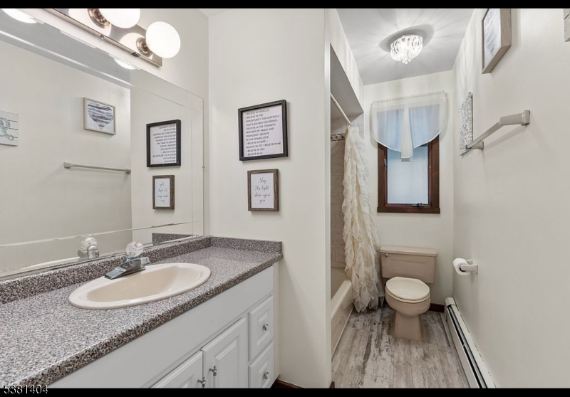 56 Sleepy Hollow Road Andover, NJ 07821 - Photo 25 of 37 a bathroom with a sink toilet a mirror and vanity