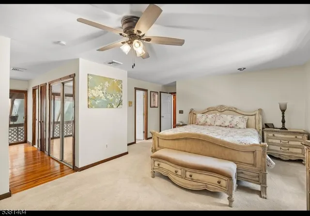 a spacious bathroom with double vanity a mirror and a lamp