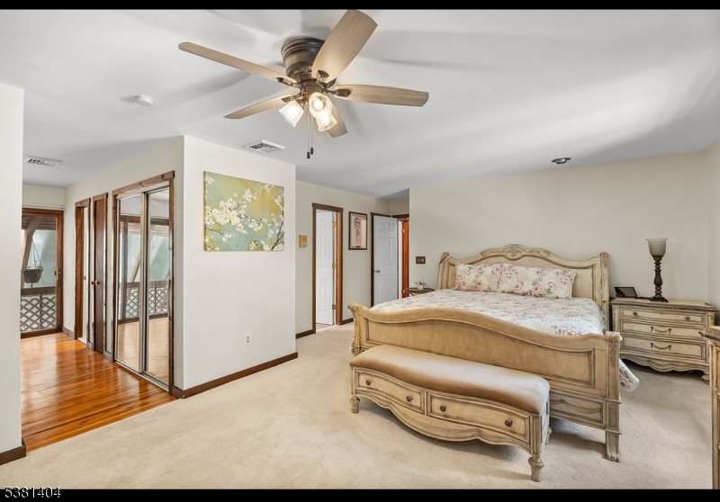 56 Sleepy Hollow Road Andover, NJ 07821 - Photo 27 of 37 a bedroom with a bed and a chandelier