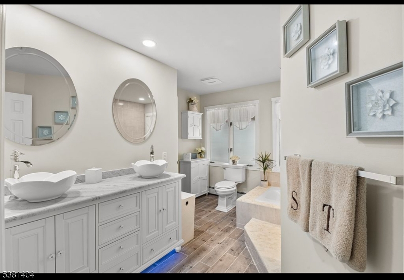 56 Sleepy Hollow Road Andover, NJ 07821 - Photo 30 of 37 a spacious bathroom with double vanity a mirror and a lamp