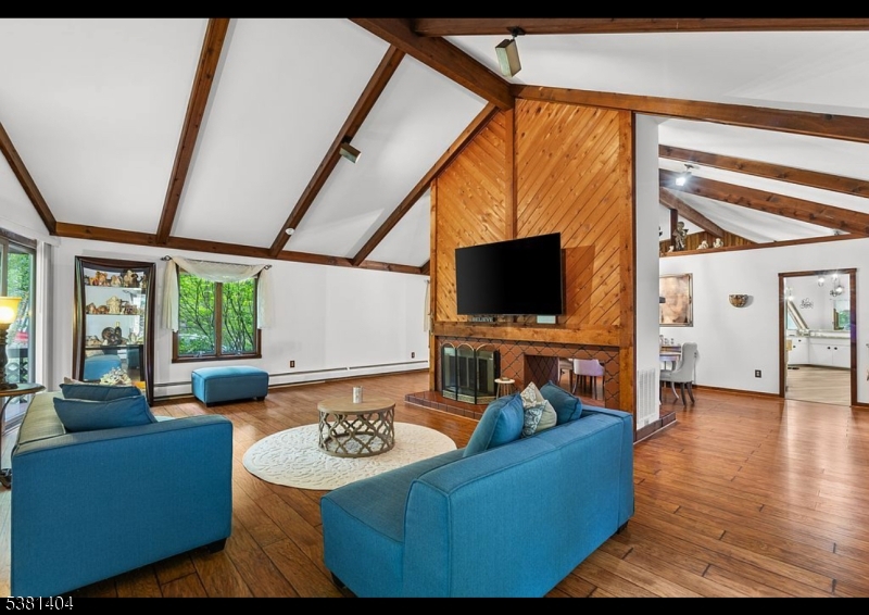 56 Sleepy Hollow Road Andover, NJ 07821 - Photo 4 of 37 a living room with furniture and a flat screen tv