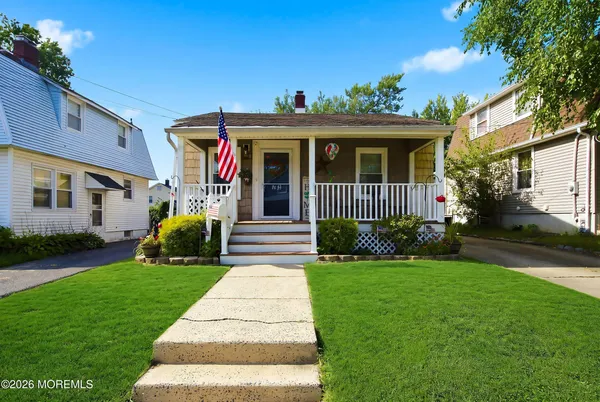 a front view of a house with a yard and porch