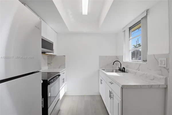 a kitchen with a sink stove and refrigerator
