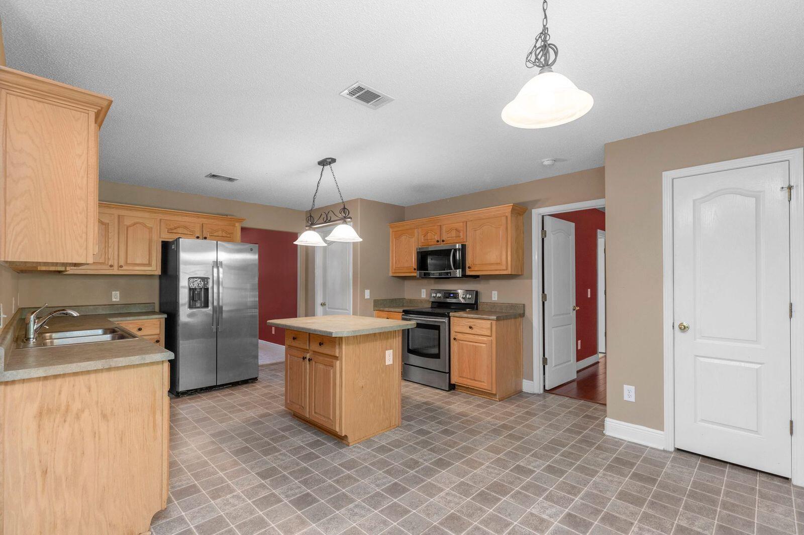 238 Foxchase Way Crestview, FL 32536 - Photo 11 of 33 a kitchen with a refrigerator and a sink