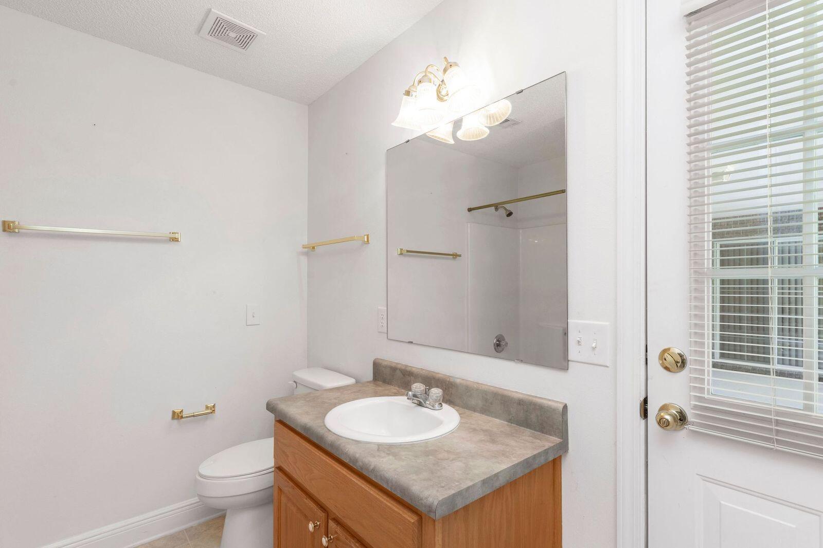 238 Foxchase Way Crestview, FL 32536 - Photo 18 of 33 a bathroom with a granite countertop sink and a mirror
