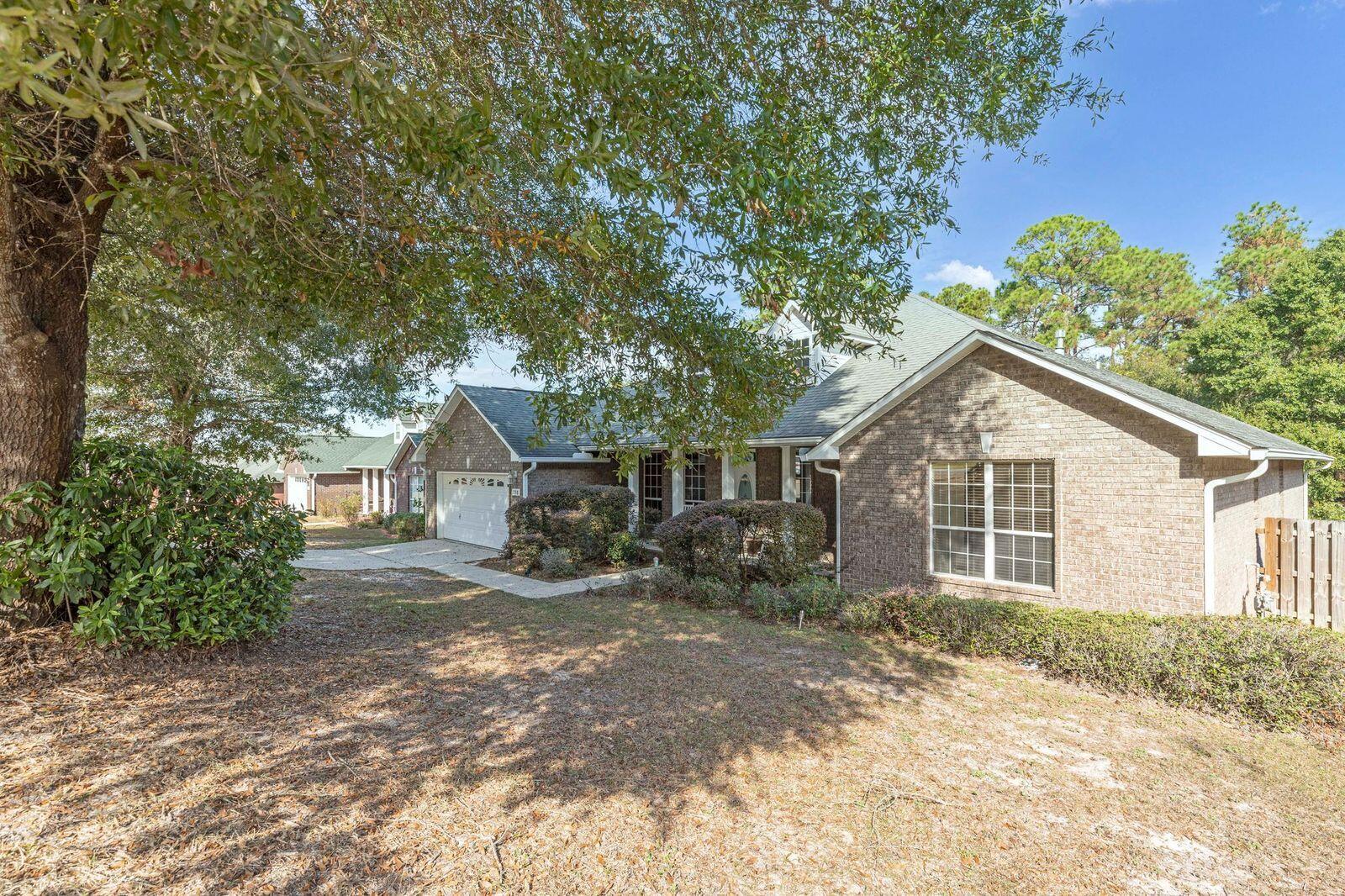 238 Foxchase Way Crestview, FL 32536 - Photo 2 of 33 a view of a house with a yard and large tree