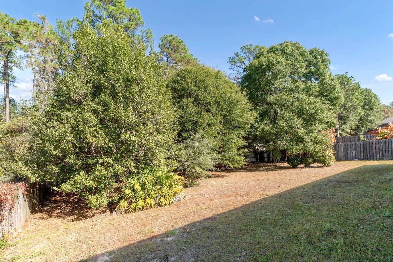 238 Foxchase Way Crestview, FL 32536 - Photo 30 of 33 a view of a yard with plants and a bench