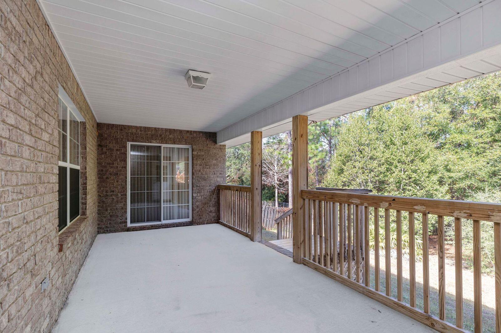 238 Foxchase Way Crestview, FL 32536 - Photo 31 of 33 a view of a porch with wooden floor and roof