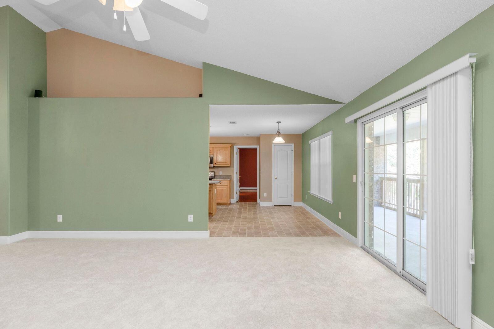 238 Foxchase Way Crestview, FL 32536 - Photo 6 of 33 a view of a room with large windows and a chandelier