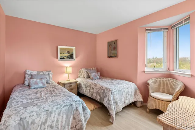 a bedroom with two beds and a couch