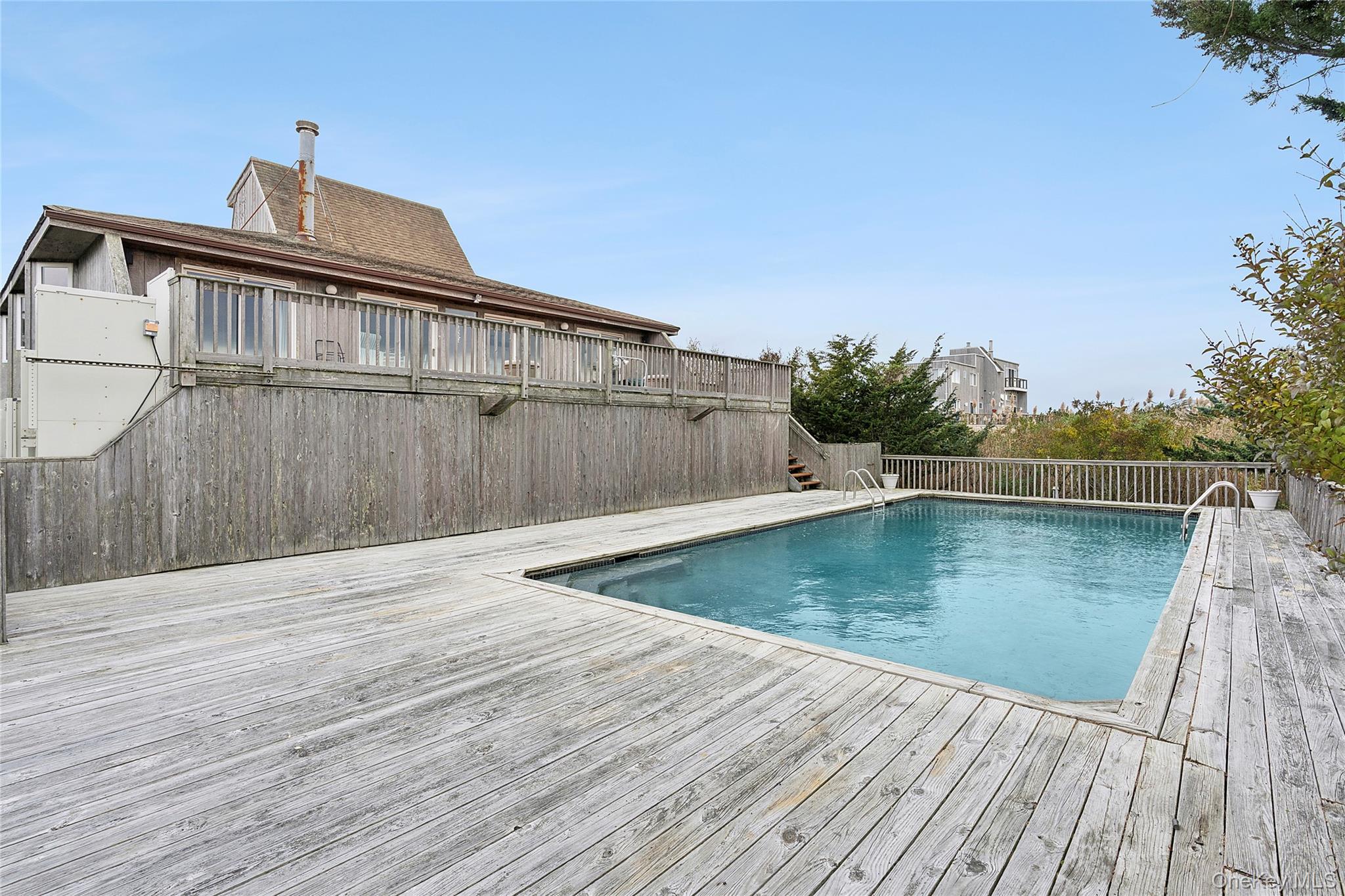 542 Dune Road Westhampton, NY 11978 - Photo 13 of 19 a view of a swimming pool with a lake view
