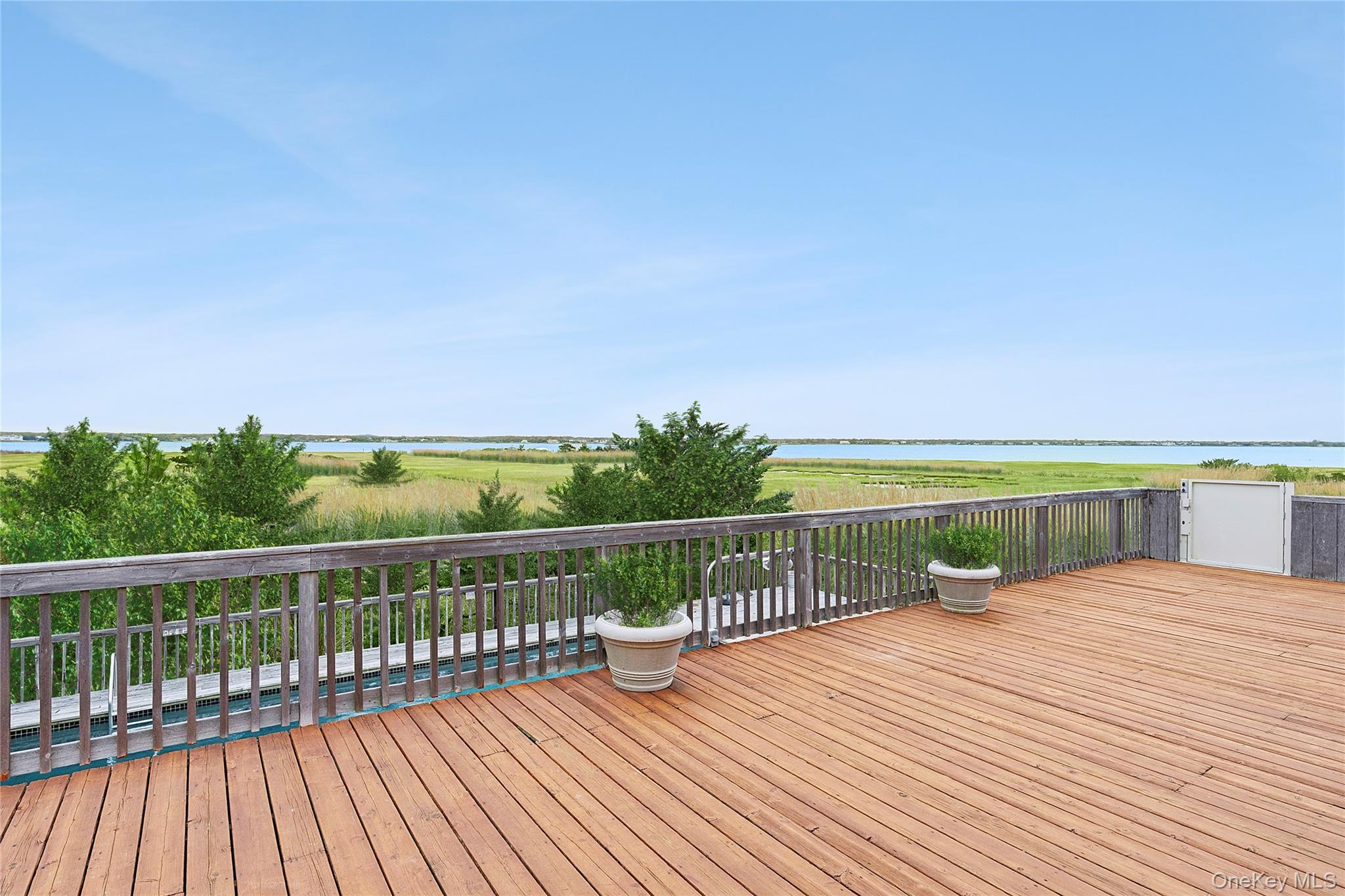 542 Dune Road Westhampton, NY 11978 - Photo 2 of 19 a view of balcony with deck and wooden floor