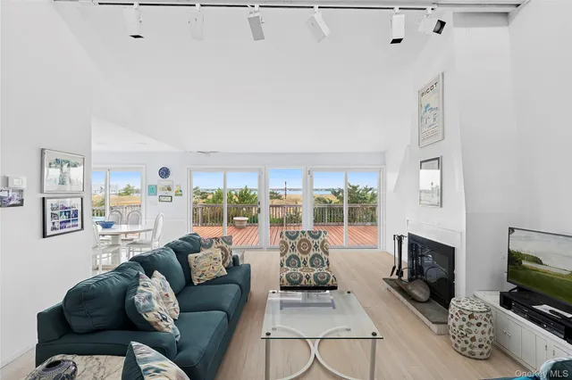 a living room with furniture a flat screen tv and a fireplace
