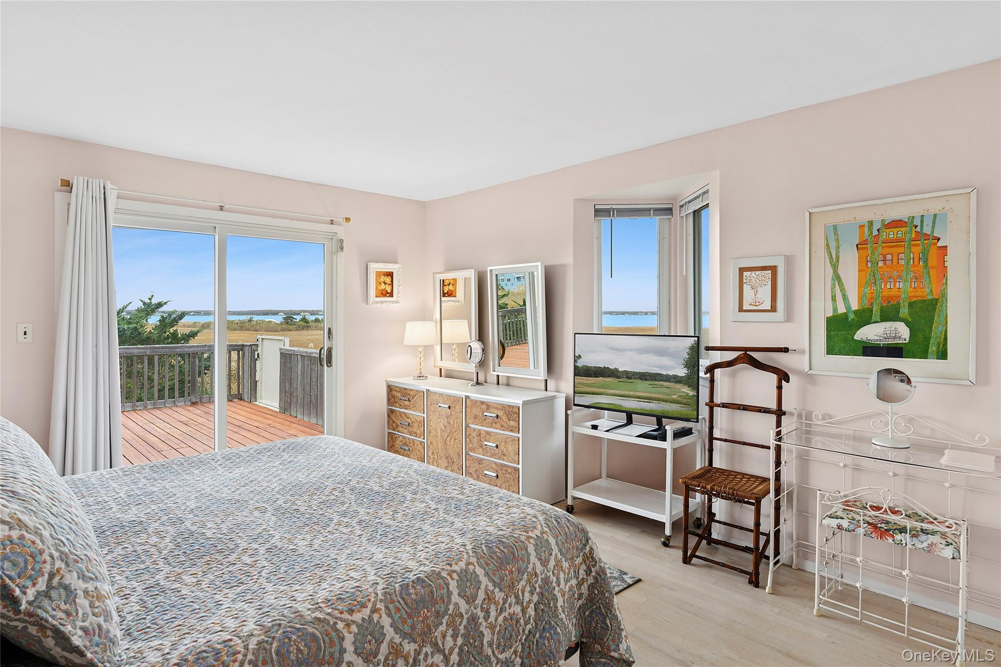 542 Dune Road Westhampton, NY 11978 - Photo 7 of 19 a bedroom with a bed and wooden floor