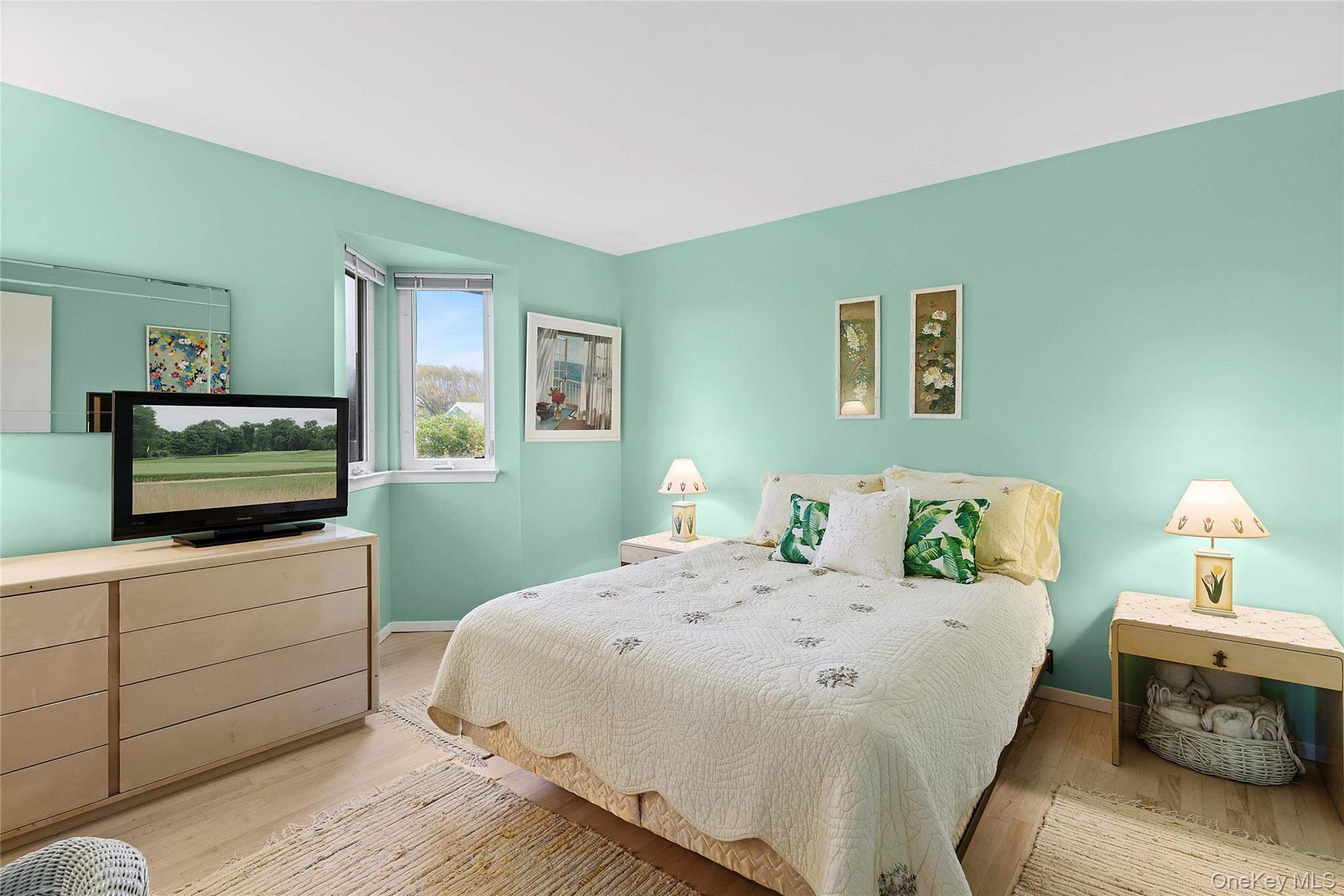 542 Dune Road Westhampton, NY 11978 - Photo 9 of 19 a bedroom with a bed and a flat screen tv