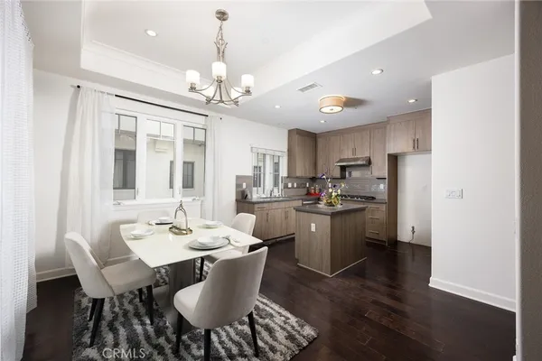 a view of a dining room with furniture wooden floor and chandelier