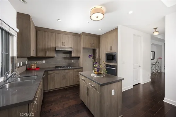 a kitchen with stainless steel appliances a sink stove and cabinets