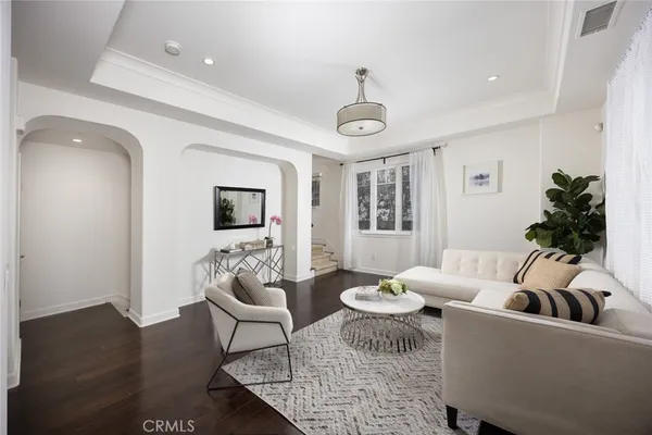 a living room with furniture wooden floor and a window