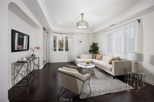 a living room with furniture wooden floor and a table