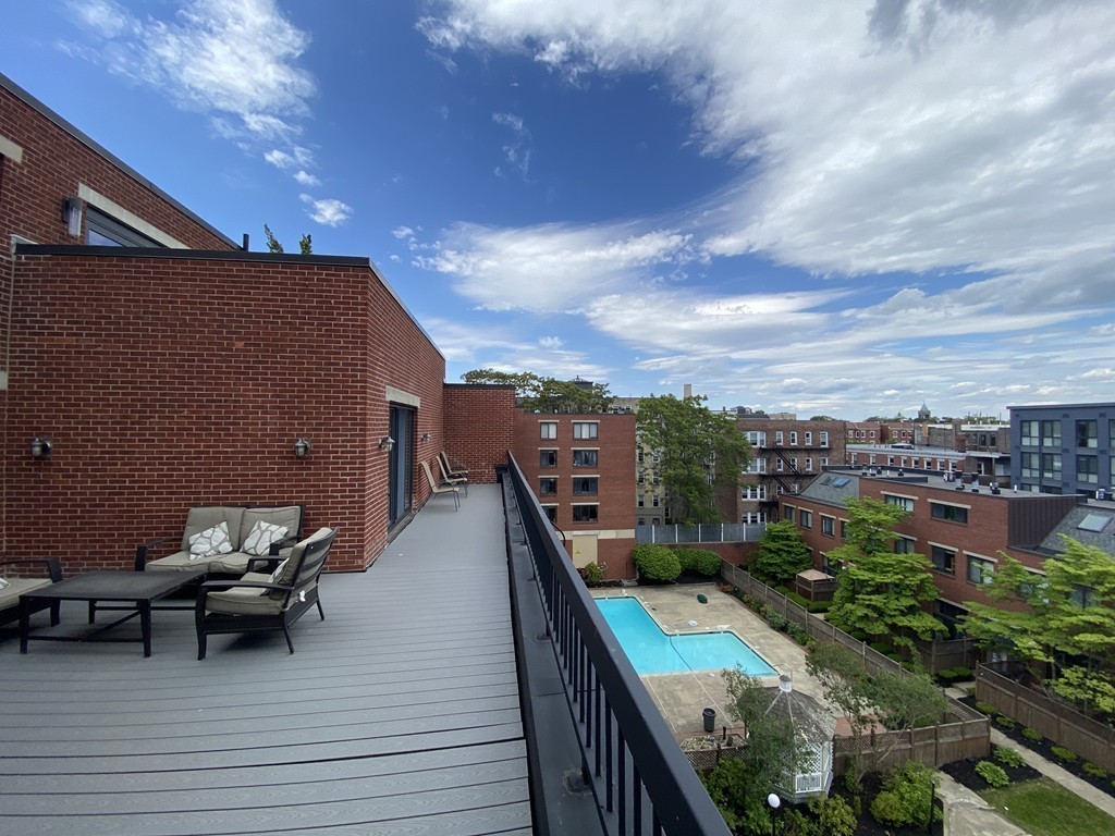 85 Brainerd Road, Unit 510 Boston, MA 02134 - Photo 18 of 25 a terrace with outdoor seating and city view