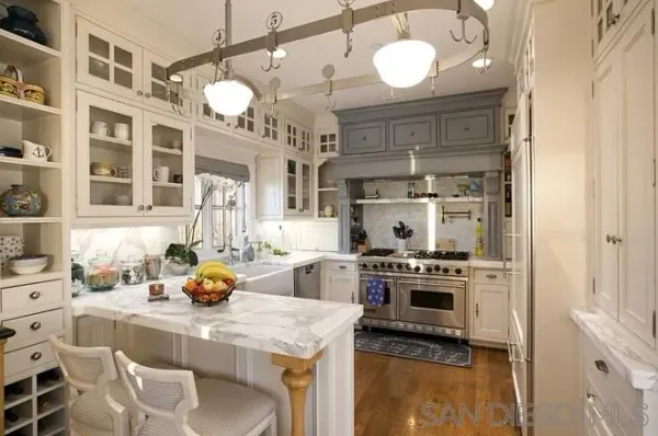 a kitchen with a stove a sink and a chandelier