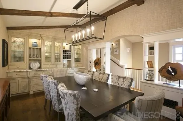a living room with couches a dining table and chairs with outer view