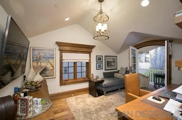 a living room with furniture chandelier and fireplace