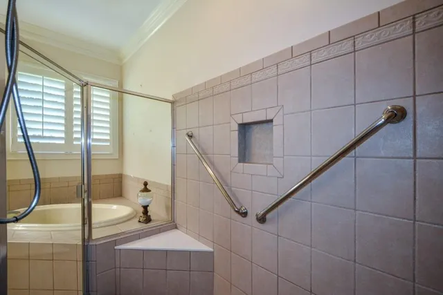 a view of a big yard with table and chairs under an umbrella