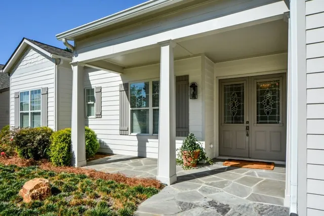 a kitchen with stainless steel appliances granite countertop a table chairs refrigerator and sink
