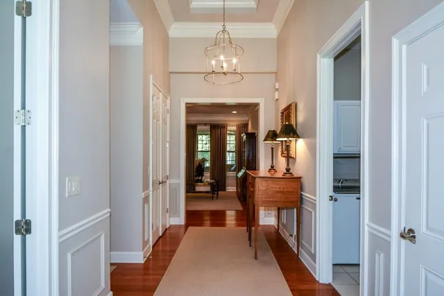 a room with stainless steel appliances kitchen island granite countertop a table chairs and a refrigerator
