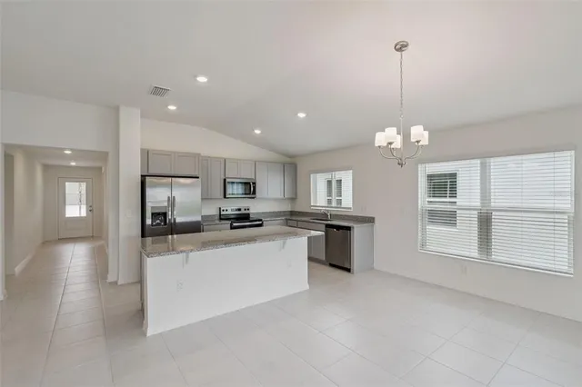 a large kitchen with a chandelier