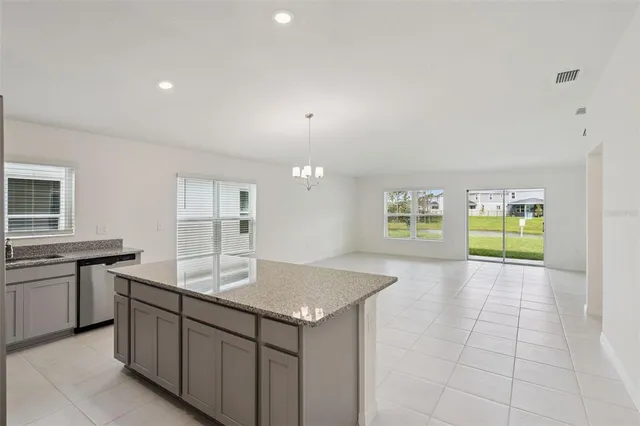 a kitchen with stainless steel appliances granite countertop a sink and a stove