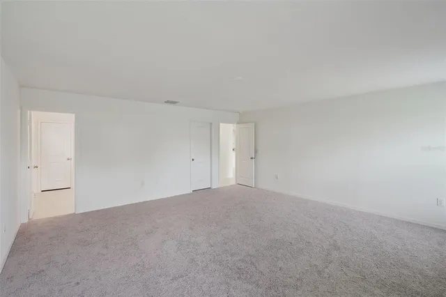 a view of an empty room and a window