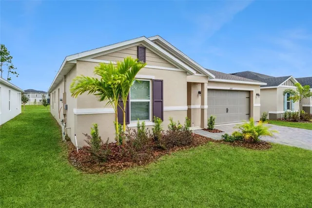 a front view of house with a garden