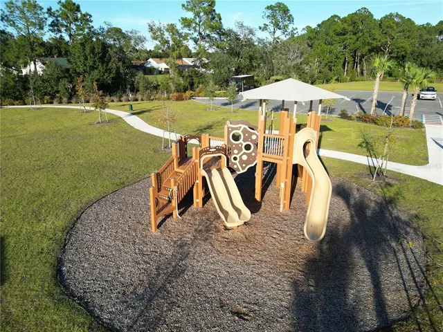 a view of swimming pool with outdoor seating and plants