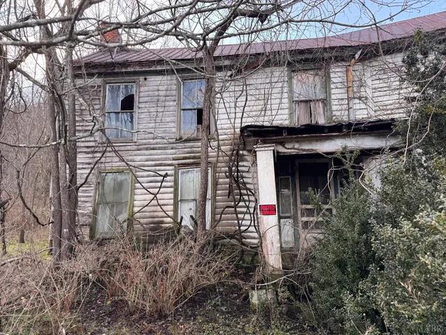 a backyard of a house with lots of green space and glass windows