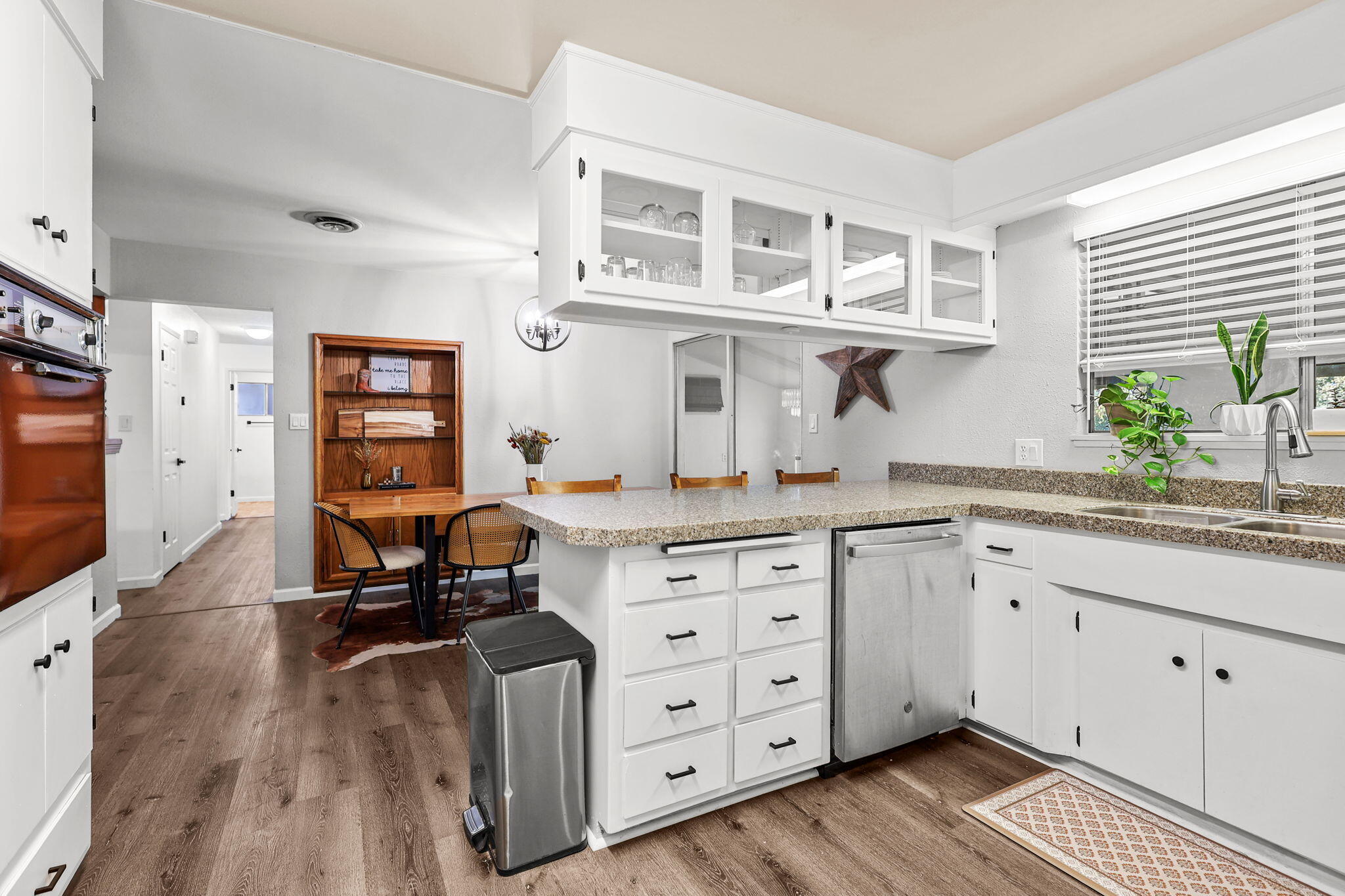 6958 Riverside Drive Redding, CA 96001 - Photo 11 of 30 a kitchen with cabinets a window and appliances
