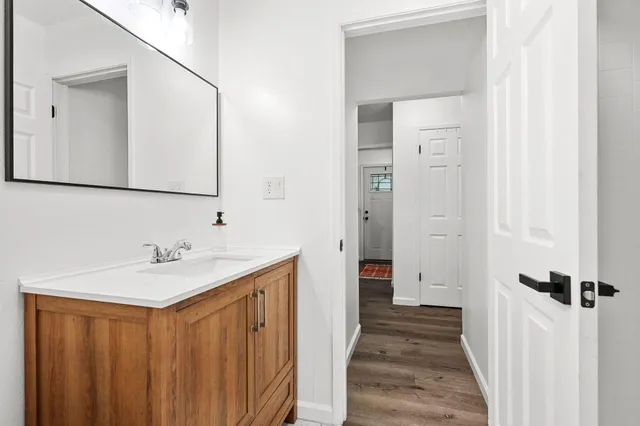 a bed sitting in a spacious bedroom next to a window