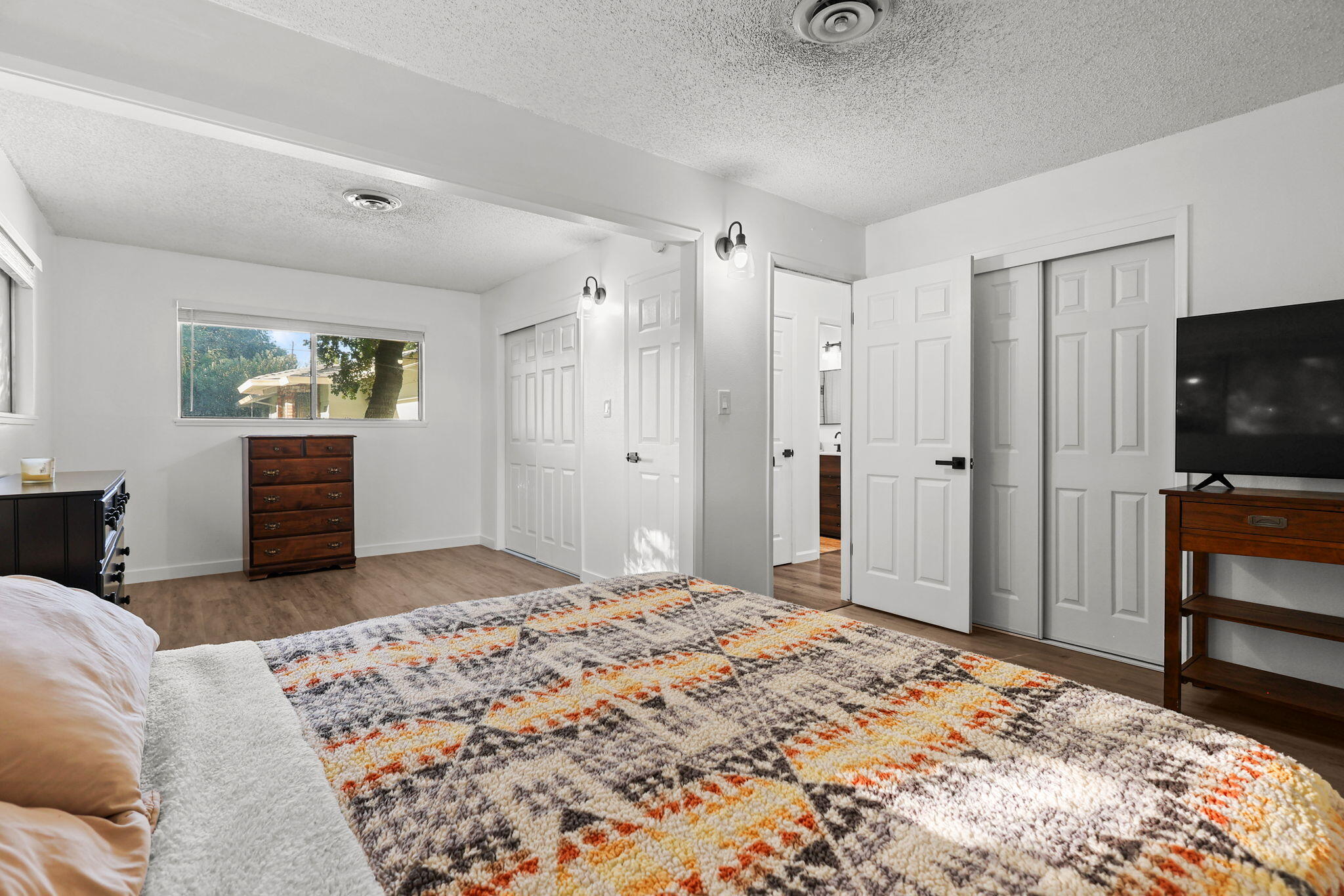 6958 Riverside Drive Redding, CA 96001 - Photo 19 of 30 a bedroom with a bed and a flat screen tv