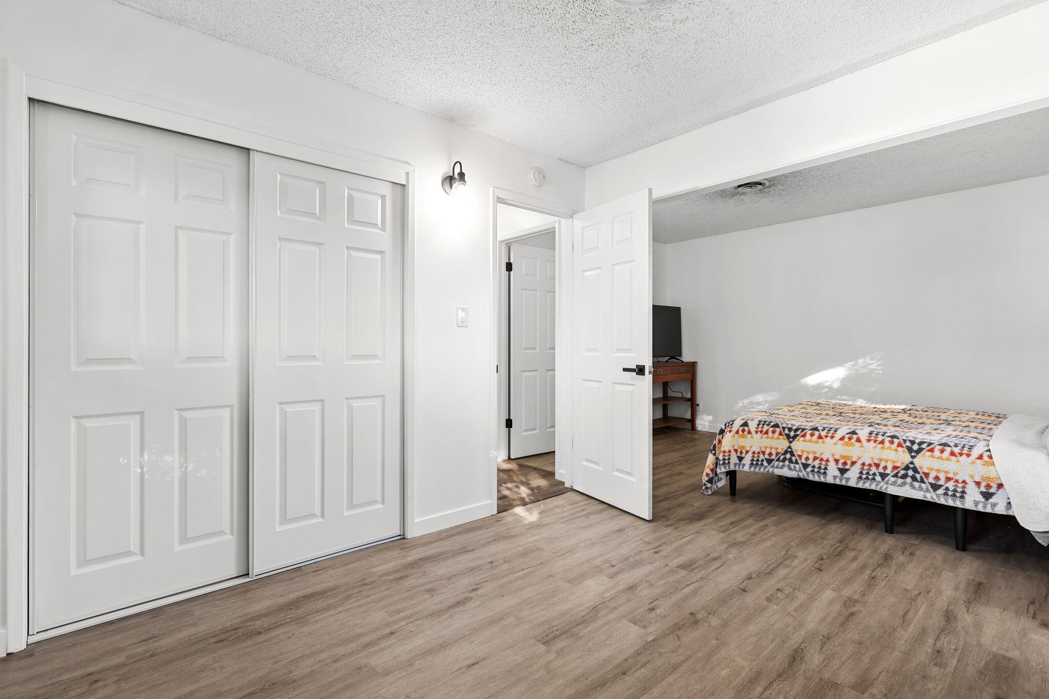 6958 Riverside Drive Redding, CA 96001 - Photo 20 of 30 a bedroom with a bed and wooden floor