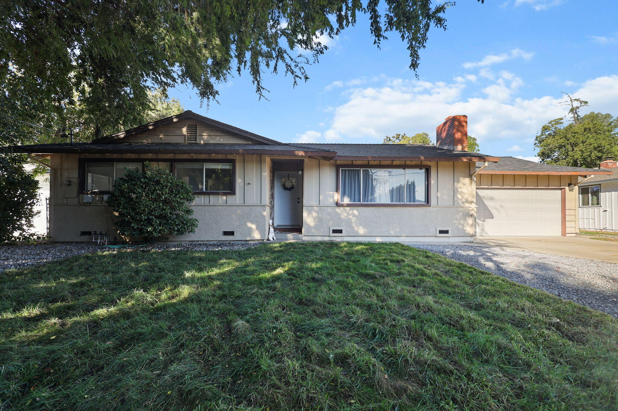 6958 Riverside Drive Redding, CA 96001 - Photo 2 of 30 a front view of house with yard and outdoor seating