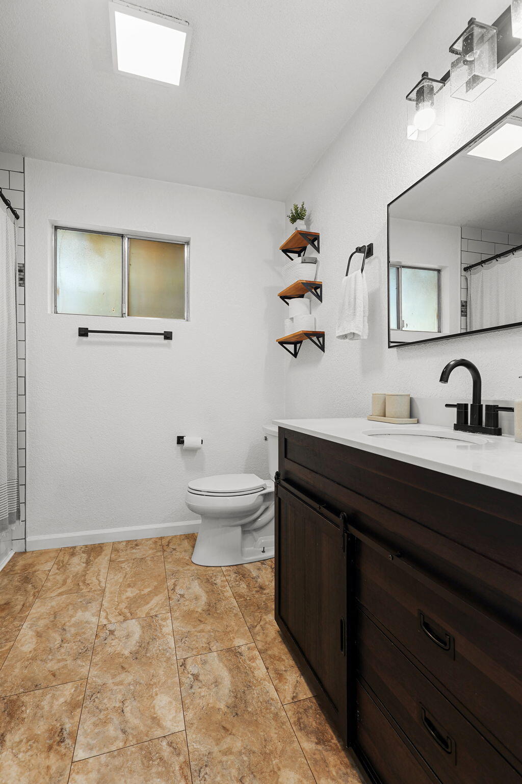 6958 Riverside Drive Redding, CA 96001 - Photo 22 of 30 a bathroom with a sink toilet and vanity