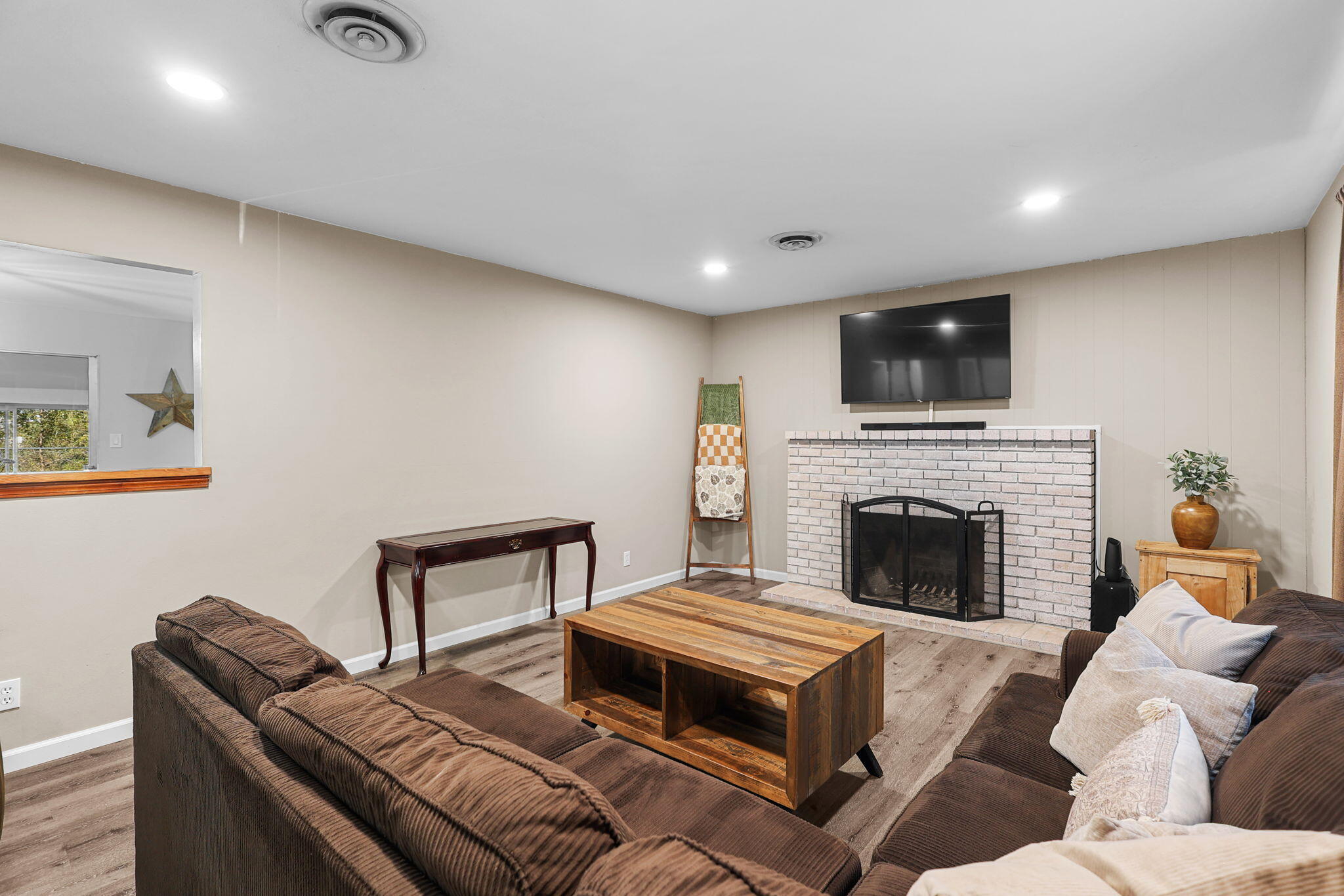 6958 Riverside Drive Redding, CA 96001 - Photo 6 of 30 a living room with furniture a flat screen tv and a fireplace