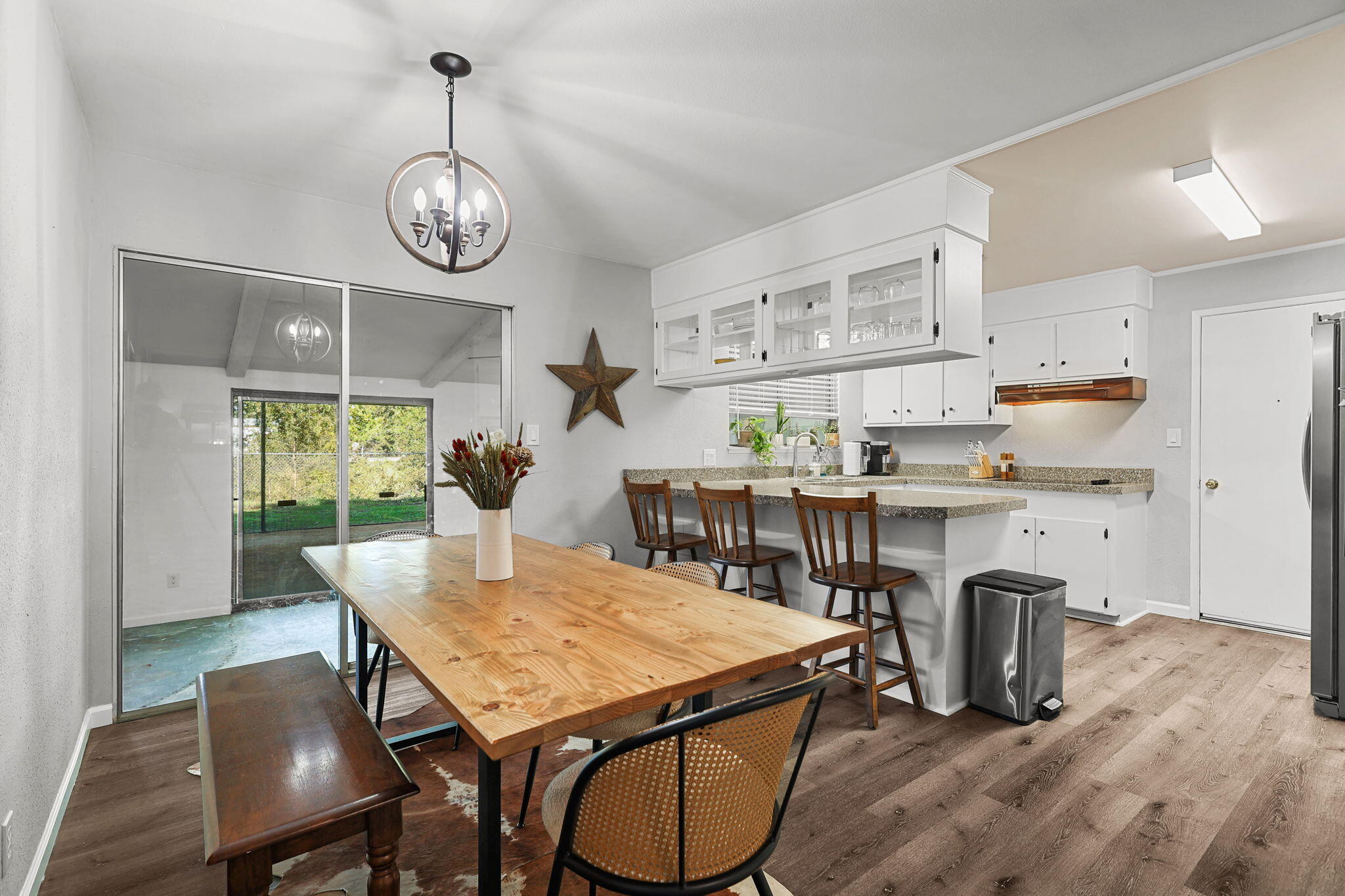 6958 Riverside Drive Redding, CA 96001 - Photo 8 of 30 a view of a dining room with furniture window and wooden floor