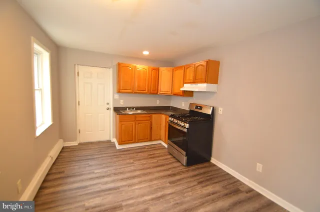 a kitchen with granite countertop a stove and a refrigerator