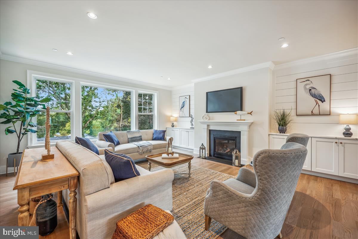 7600 Massena Road Bethesda, MD 20817 - Photo 24 of 102 a living room with furniture a large window and a fireplace