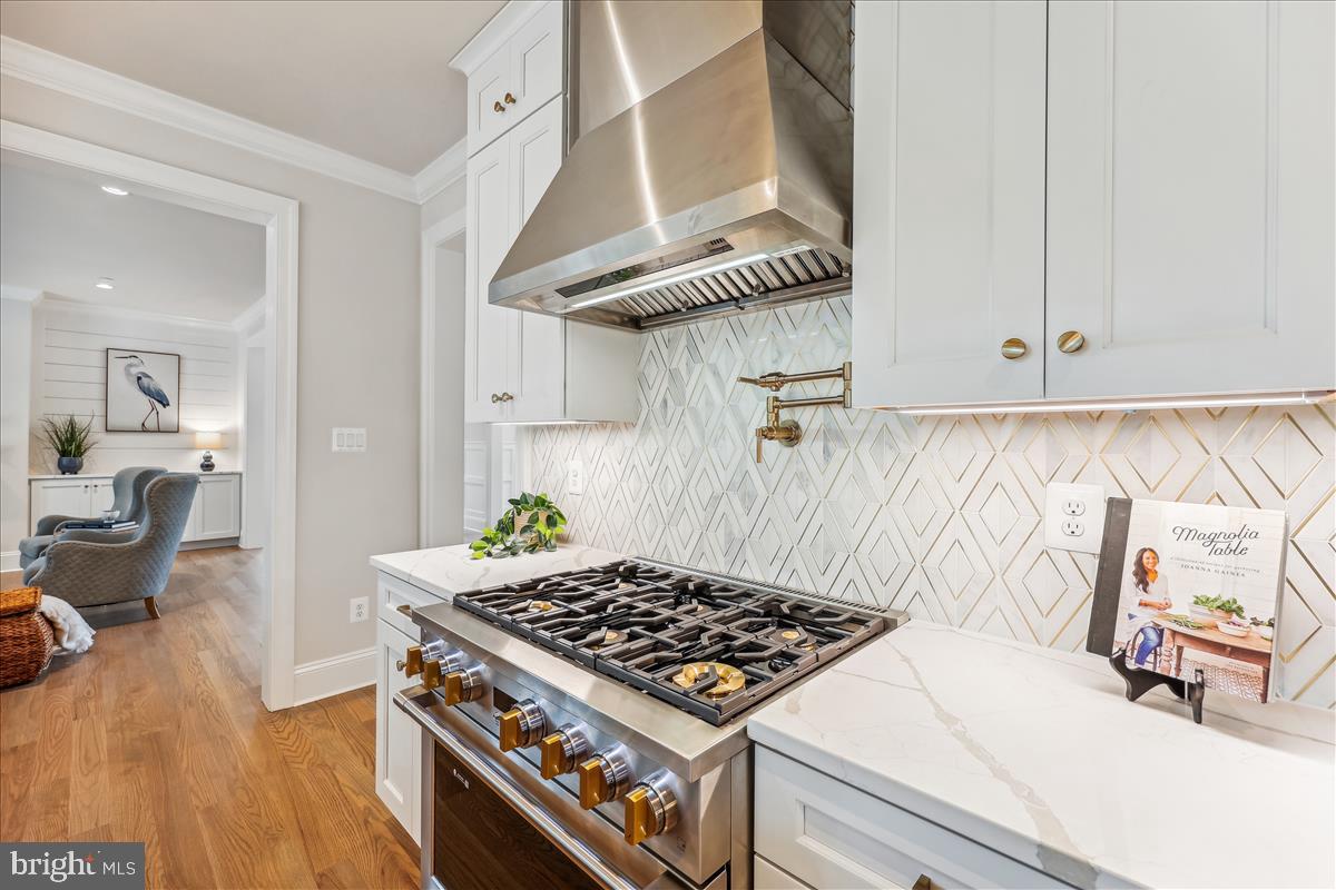 7600 Massena Road Bethesda, MD 20817 - Photo 31 of 102 a kitchen with a stove and a wooden floor