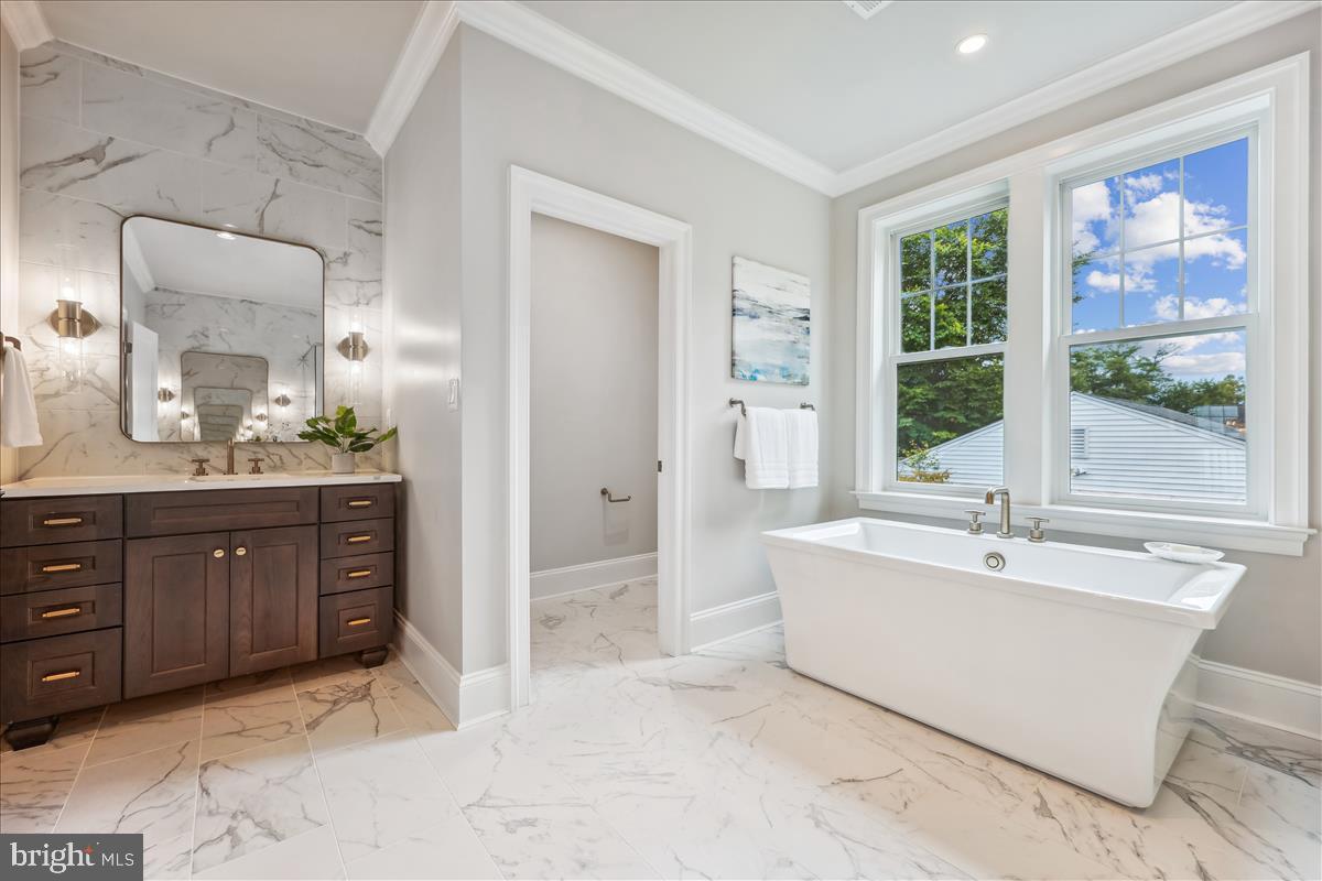 7600 Massena Road Bethesda, MD 20817 - Photo 57 of 102 a spacious bathroom with a tub sink and mirror